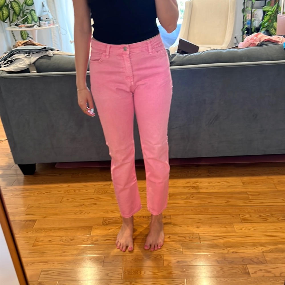 Pink mid-rise straight leg jeans.